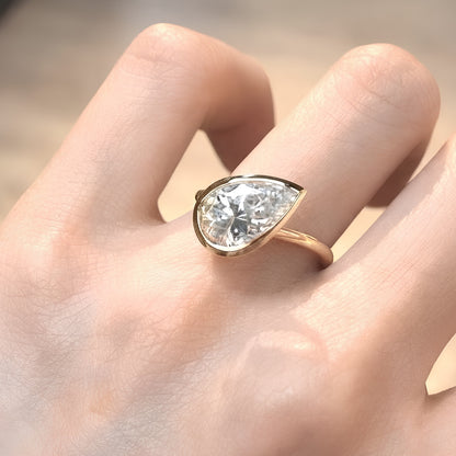 Pear Cut Bezel Set Moissanite Engagement Ring in Yellow Gold