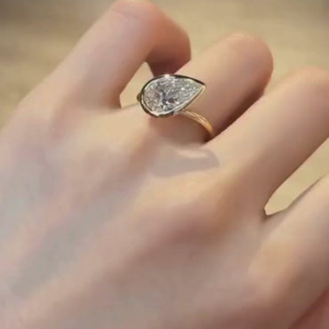 Pear Cut Bezel Set Moissanite Engagement Ring in Yellow Gold